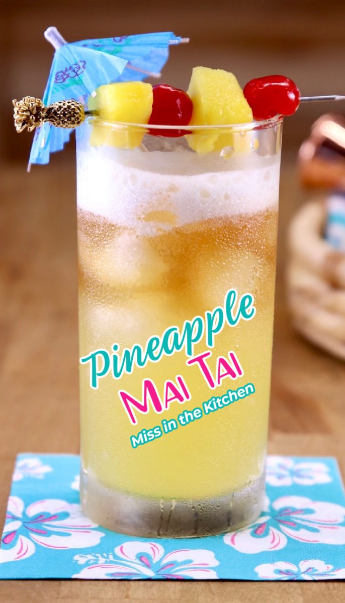 Pineapple Mai Tai Cocktail with drink umbrella and pineapple and cherry garnish