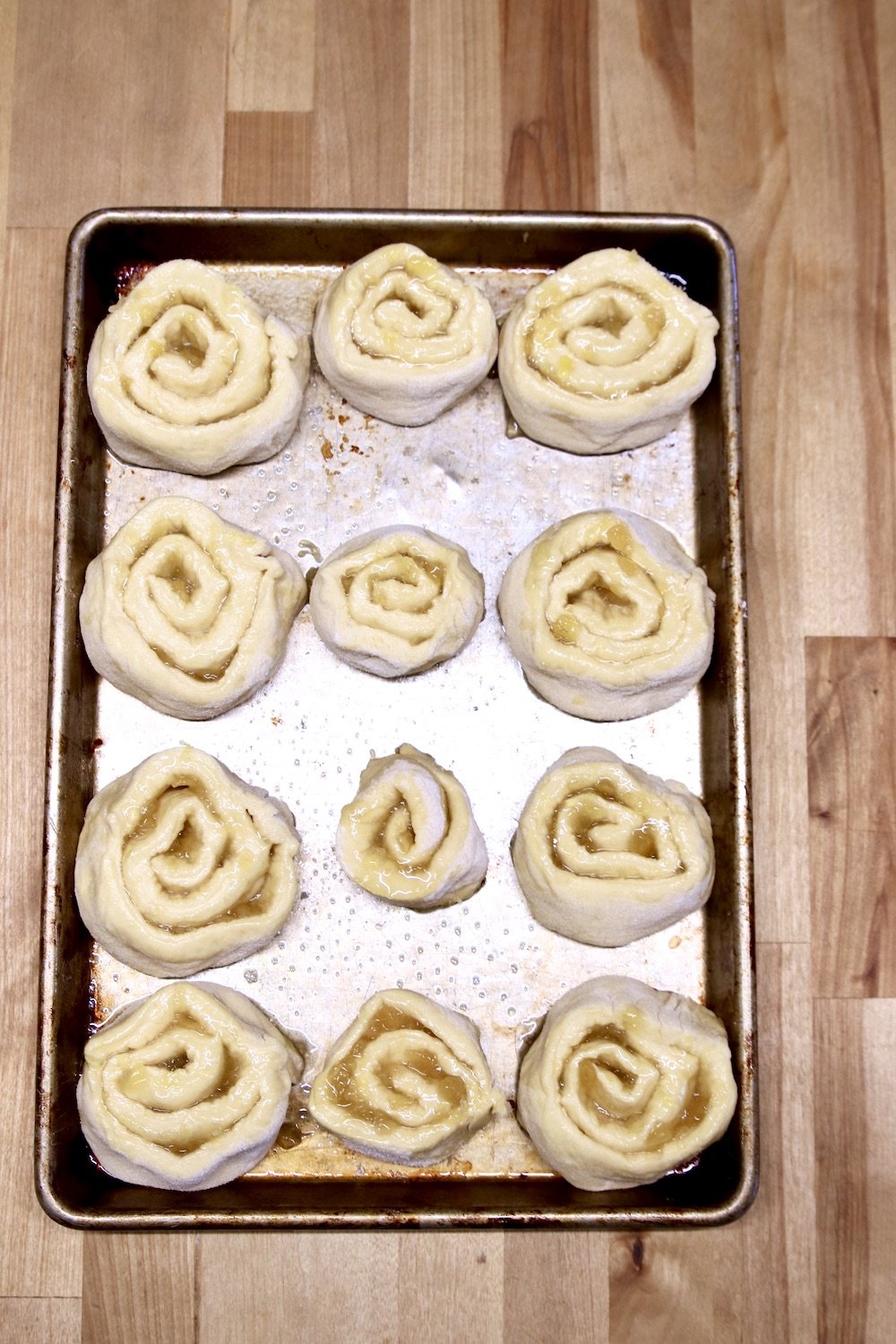 Sweet rolls on a sheet pan ready to rise