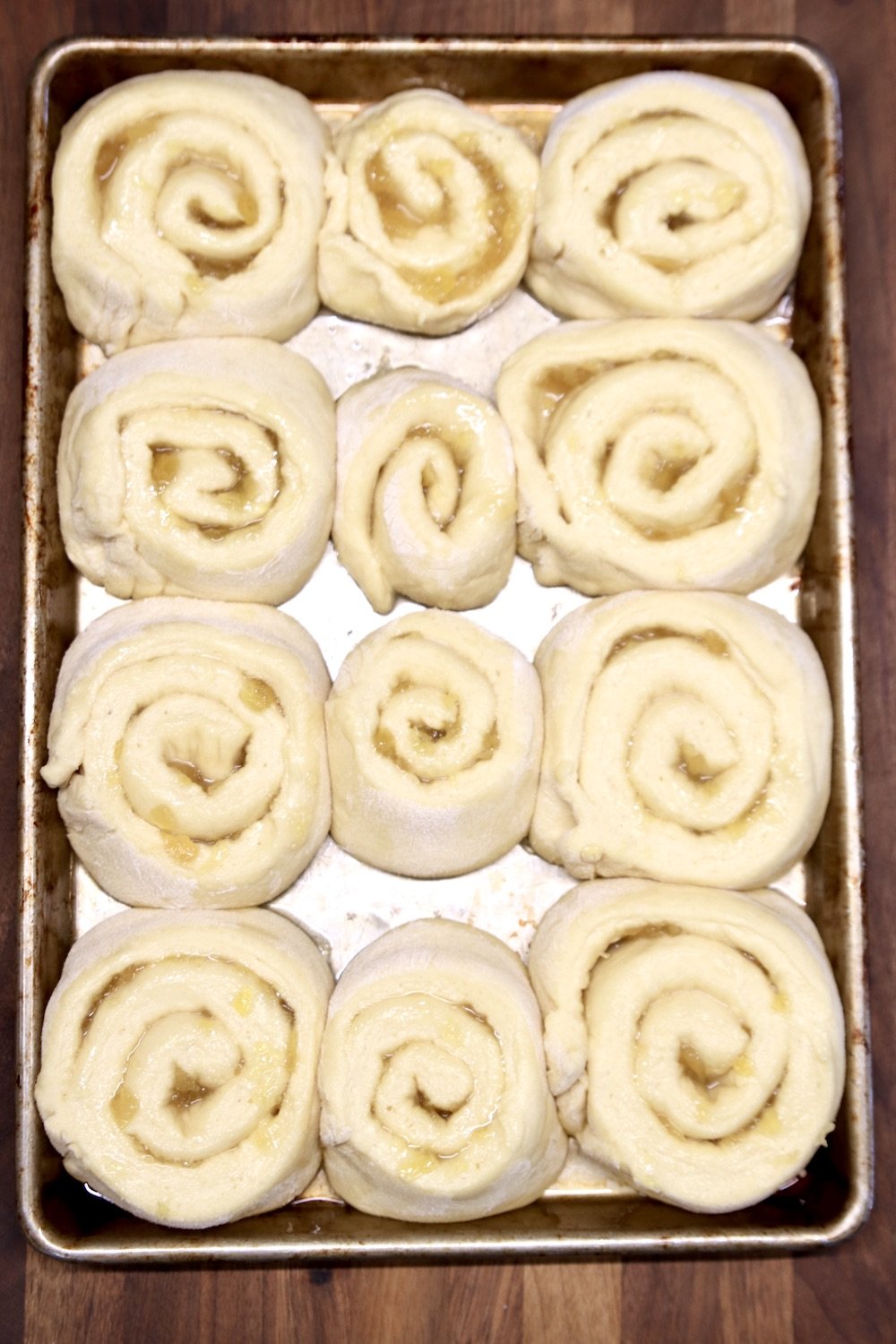 pineapple sweet rolls that are risen and ready to bake