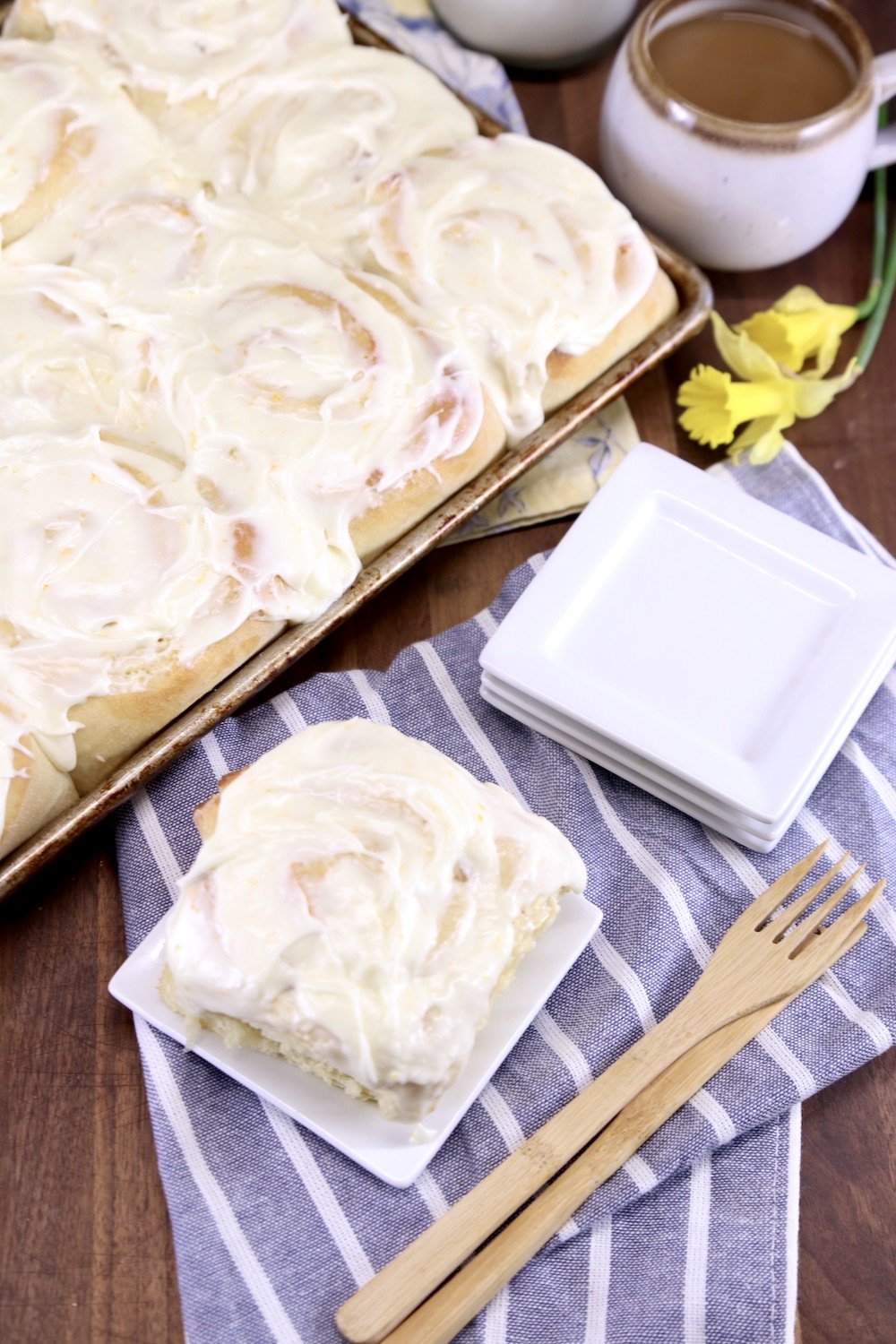 Pineapple Sweet Rolls -on a plate and pan of rolls, cup of coffee, knife and fork