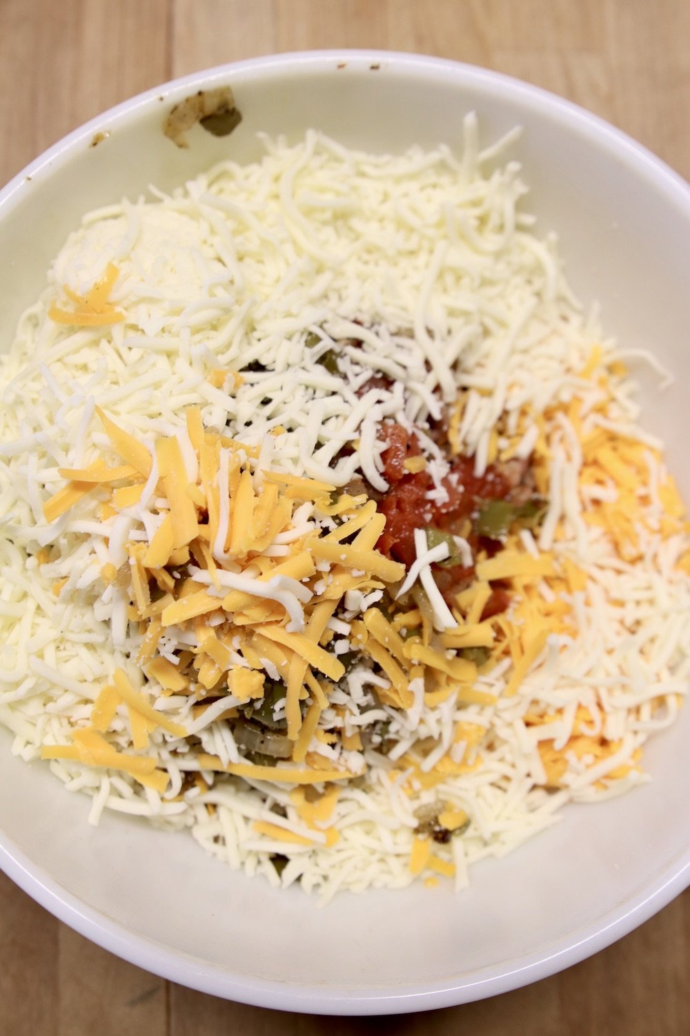 Bowl with burrito filling and shredded cheese