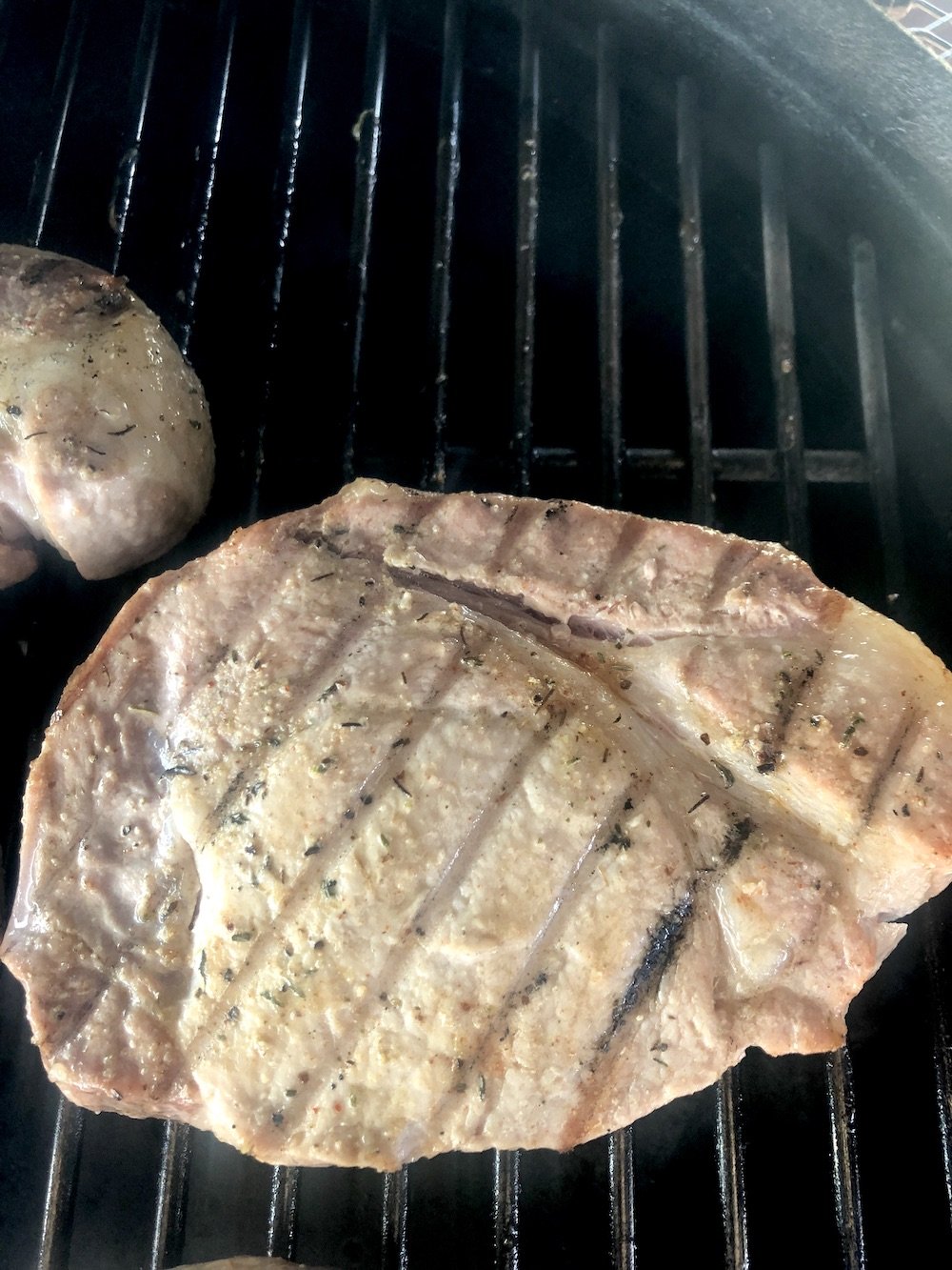 pork chop on the grill - flipped with grill marks