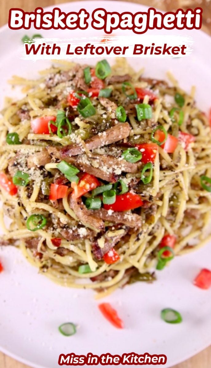 plate of brisket spaghetti with green onions, fresh tomatoes - text overlay for pinterest