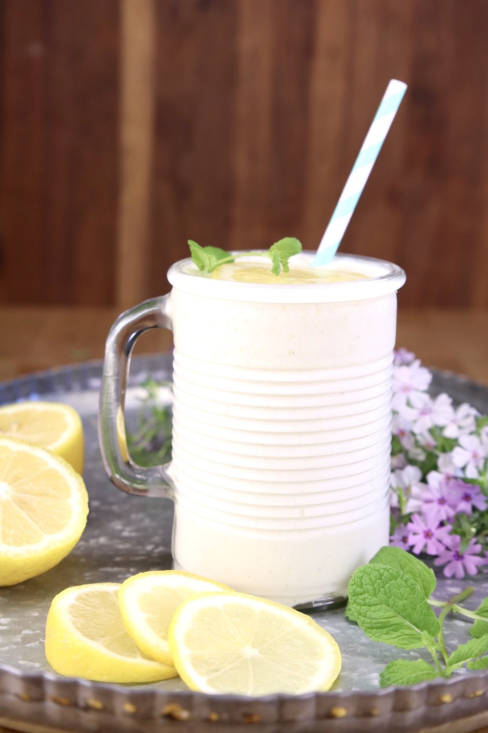 frosty lemonade in a glass with a straw