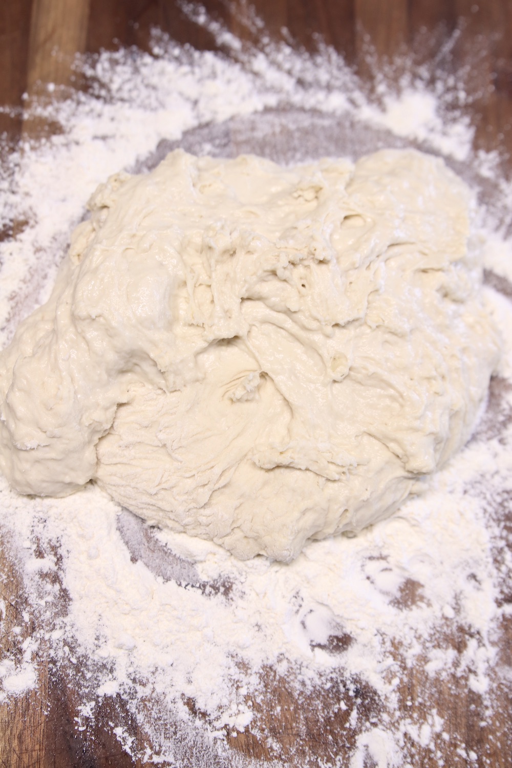 pizza dough on a floured board for kneading