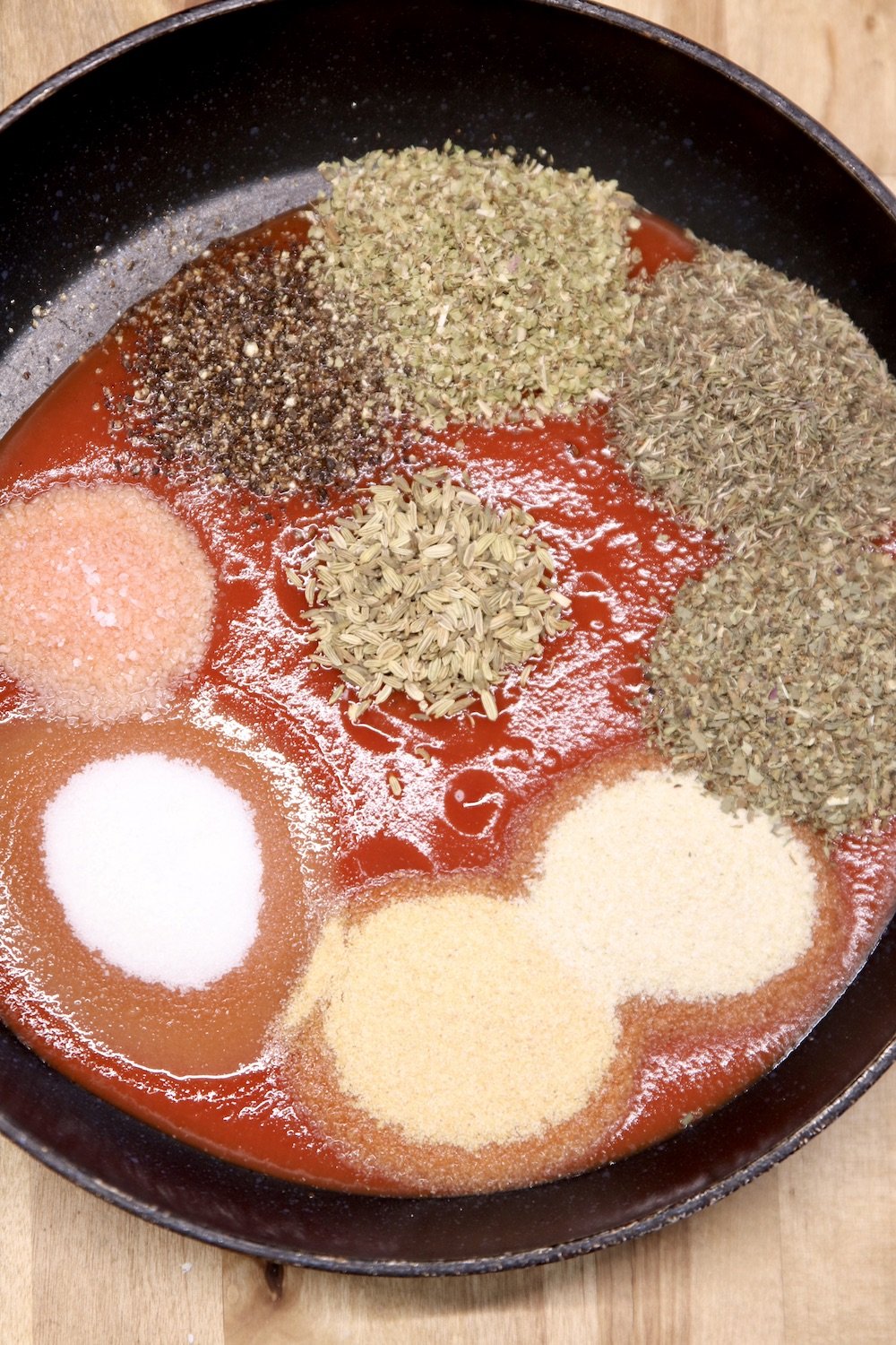 tomato sauce and spices in a pan for pizza sauce