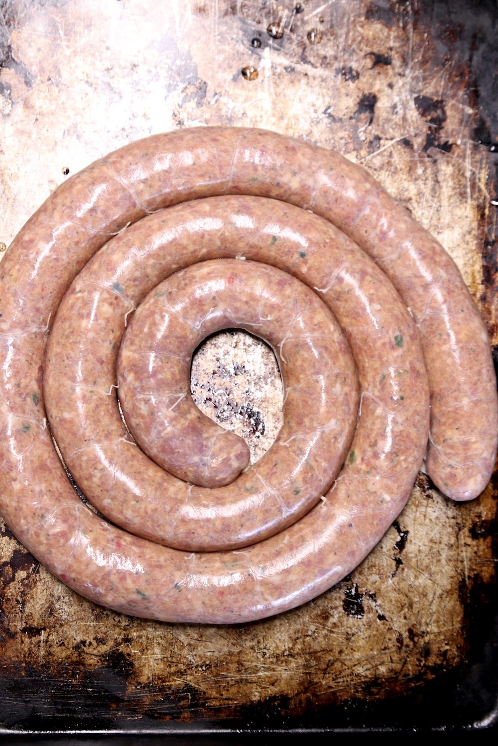coil of pork sausage in a casing