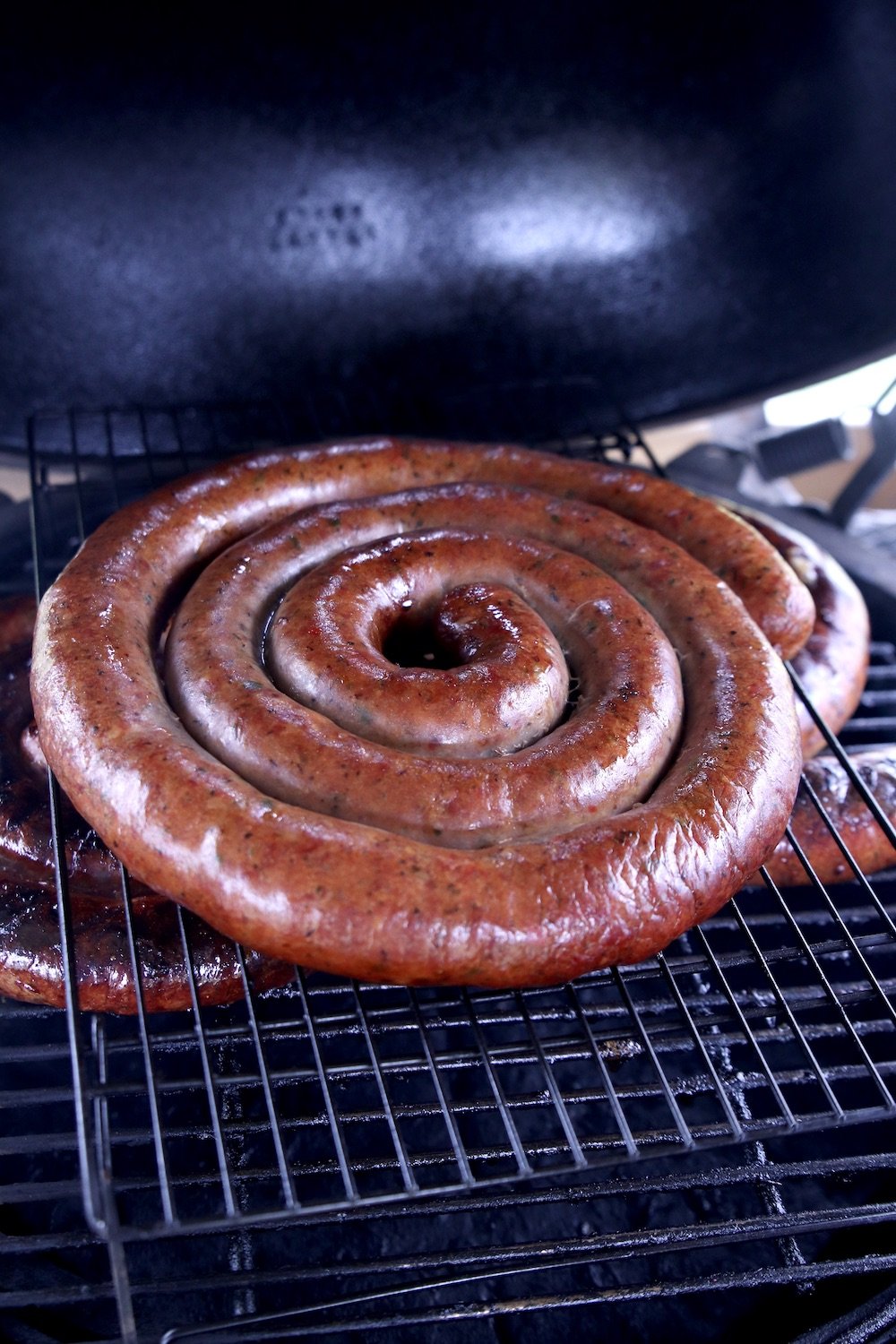 coil of smoked sausage on a grill