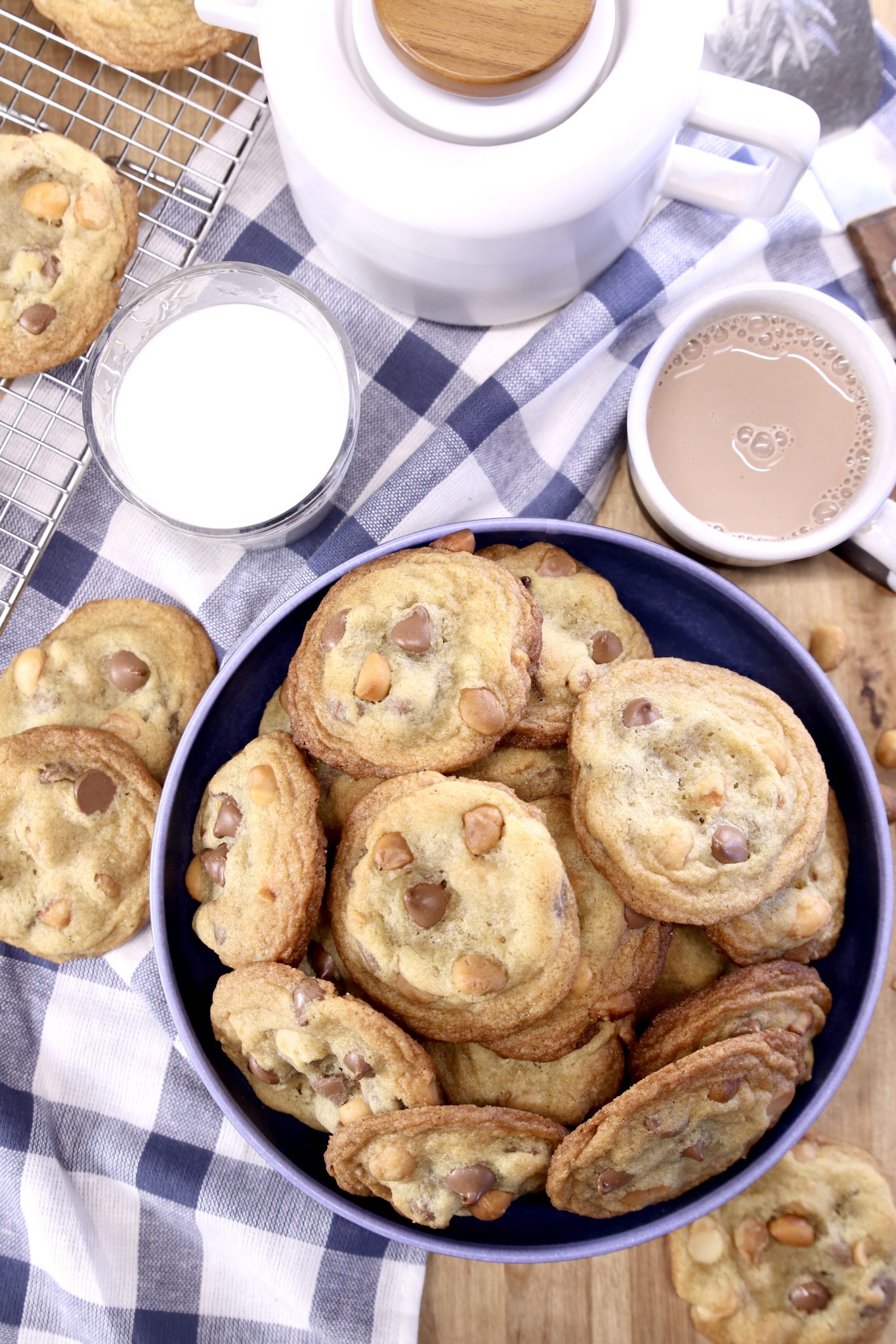 bowl of chocolate chip cookies with glass of milk, cup of hot chocolate