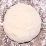 pizza dough on a floured board