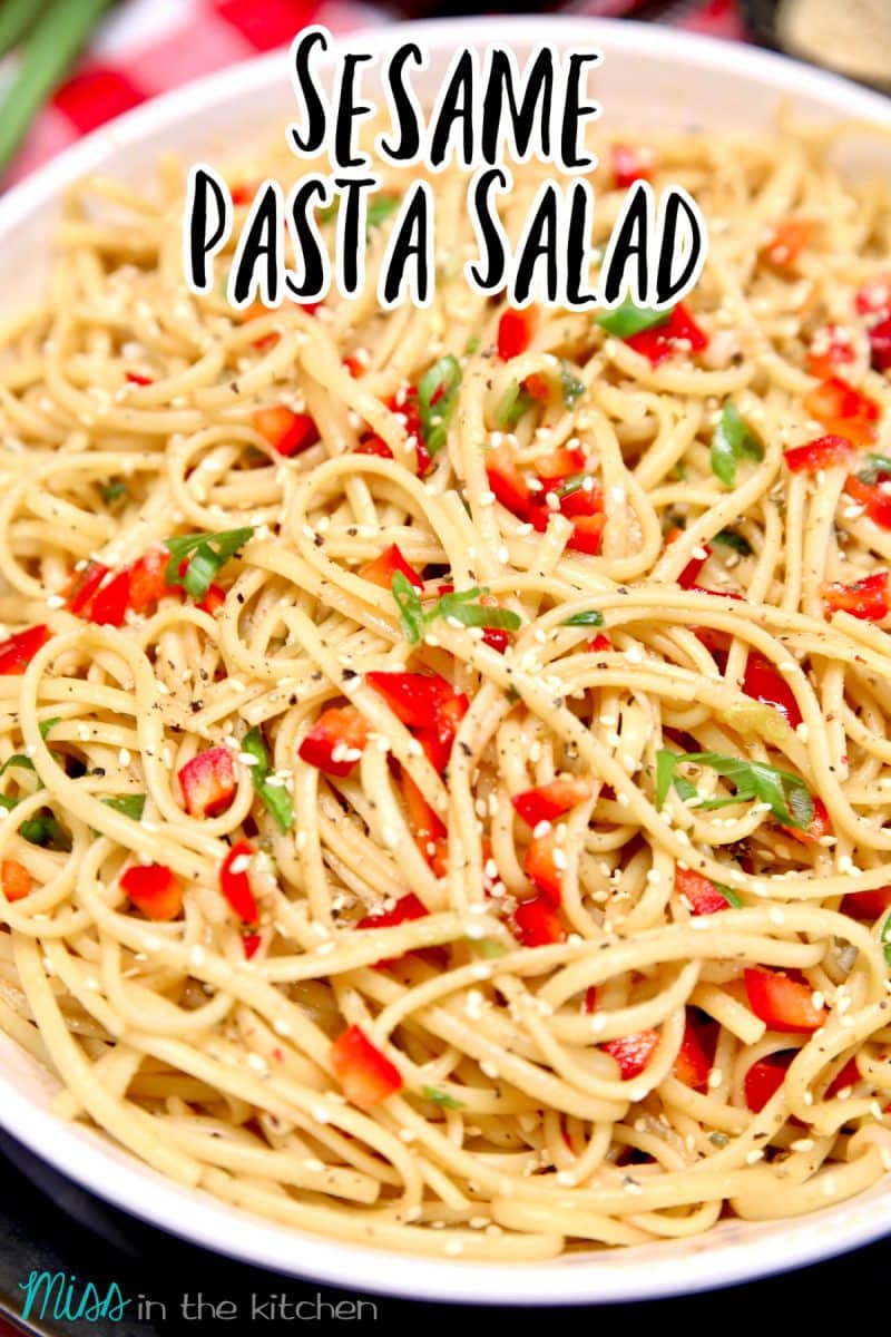 Bowl of sesame pasta salad with text overlay.
