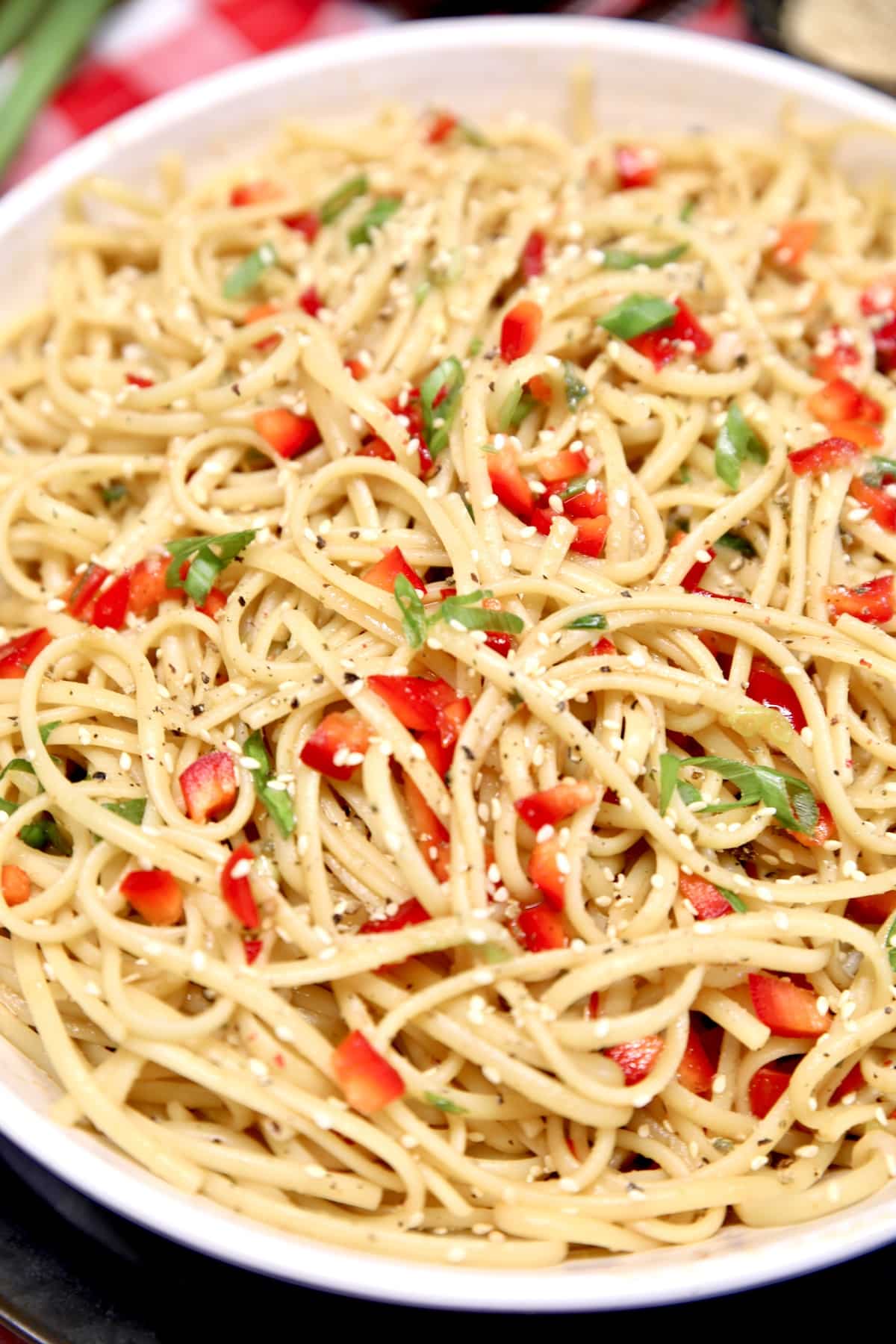 Bowl of pasta salad with red bell peppers. 