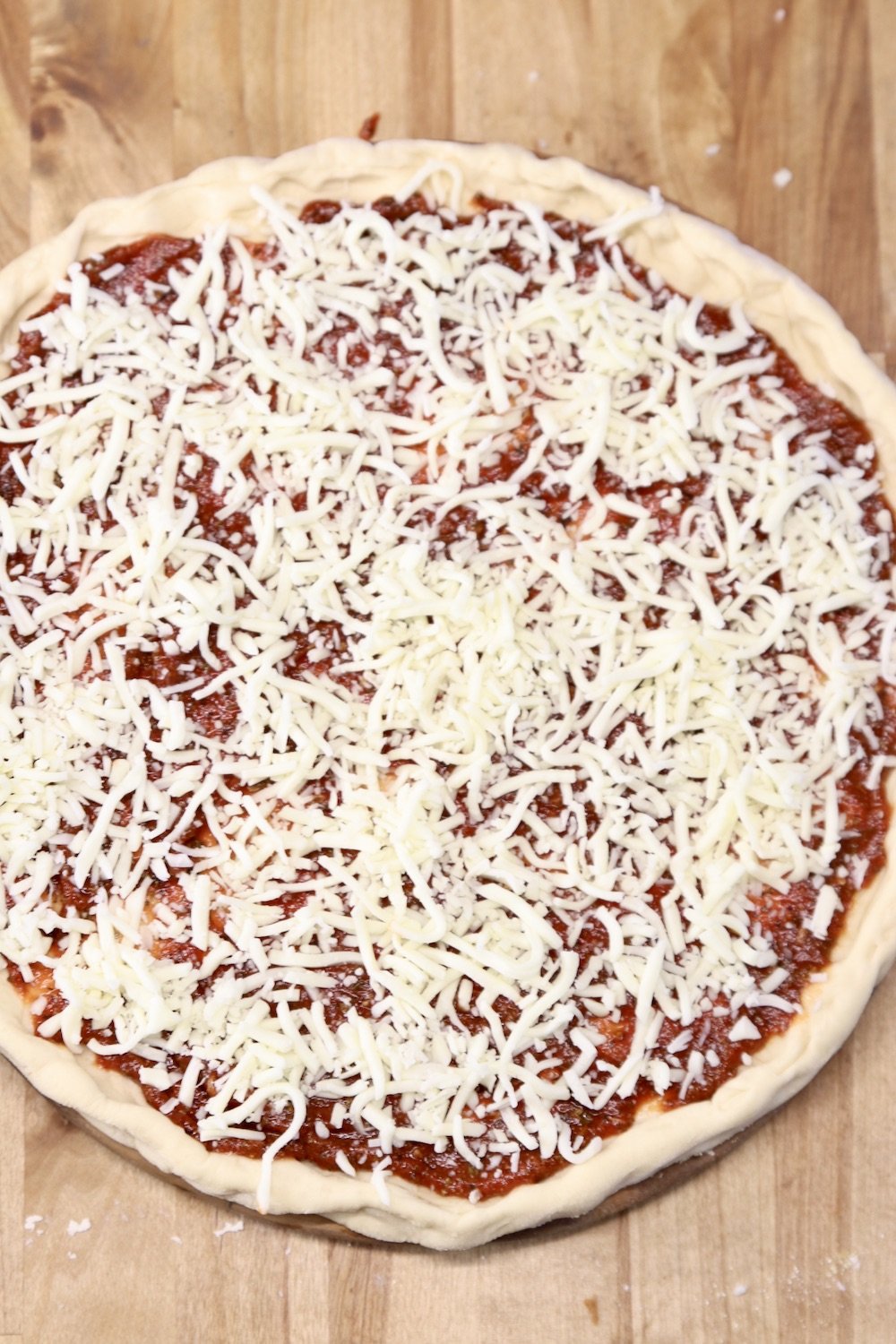 pizza topped with shredded cheese