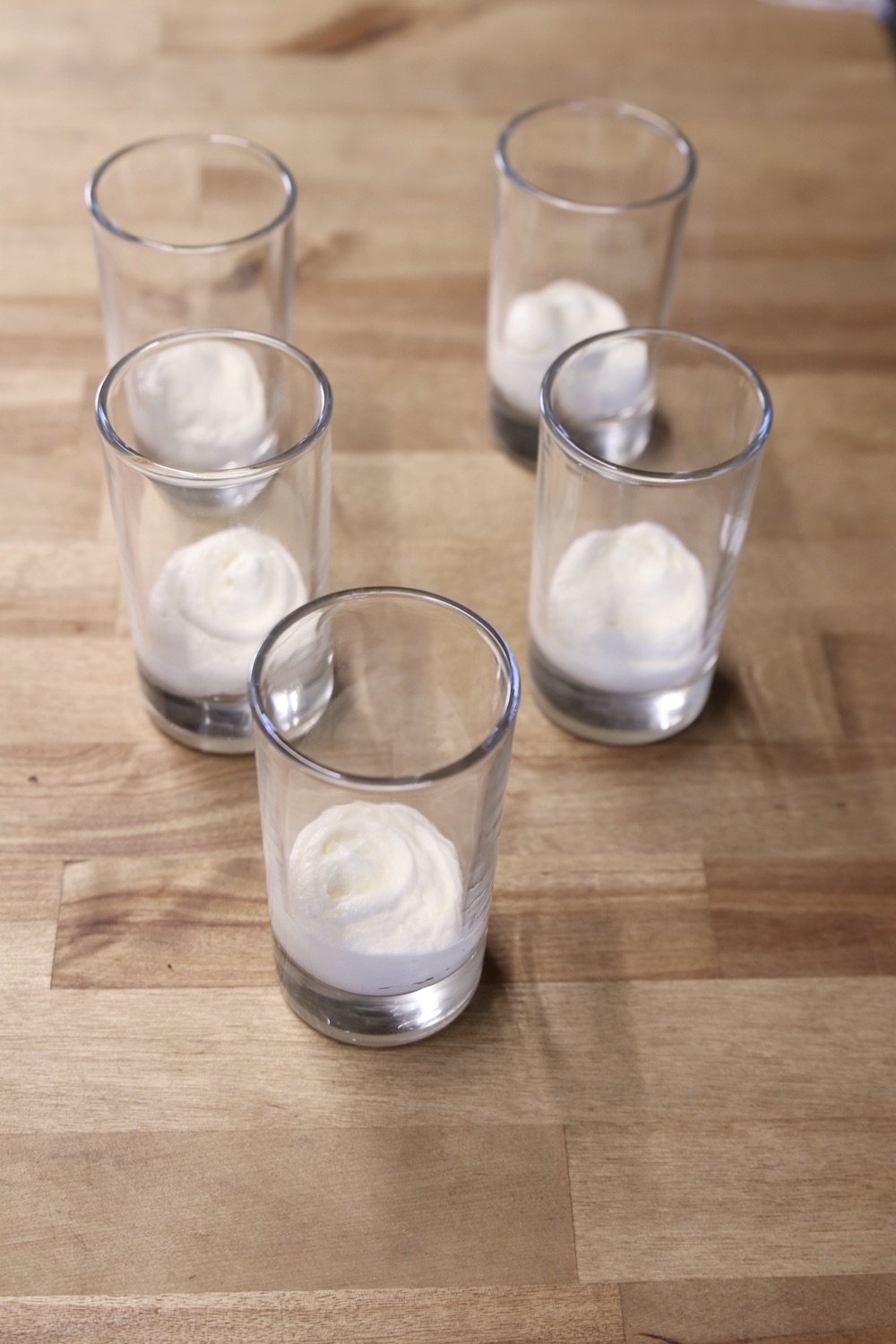 individual dessert glasses with cheesecake filling