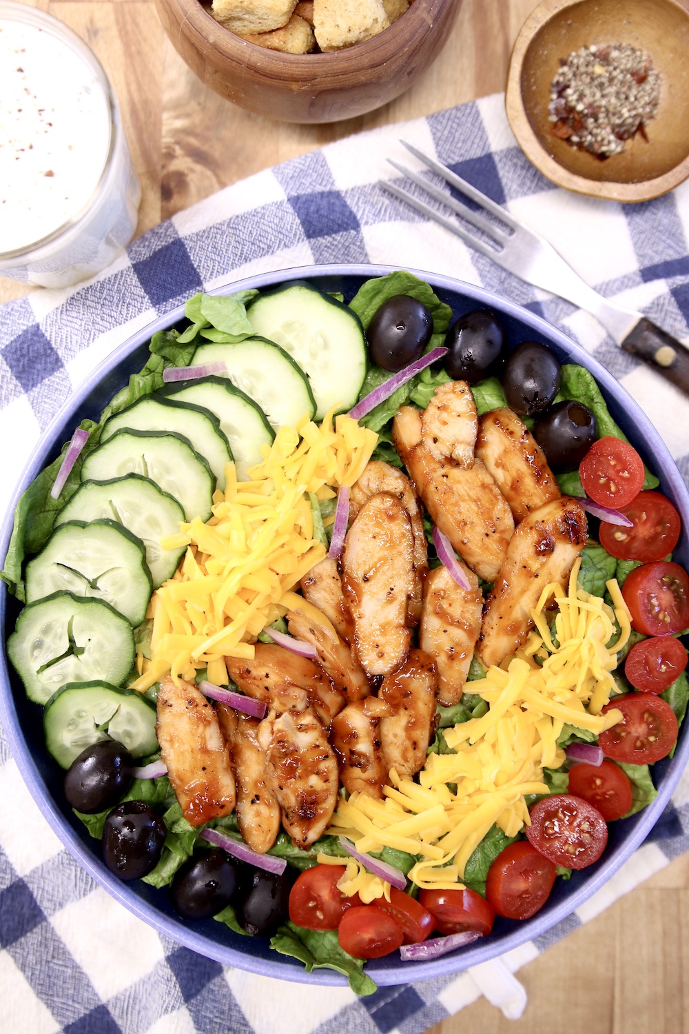 bbq chicken salad with cucumbers, tomatoes, black olives and cheese