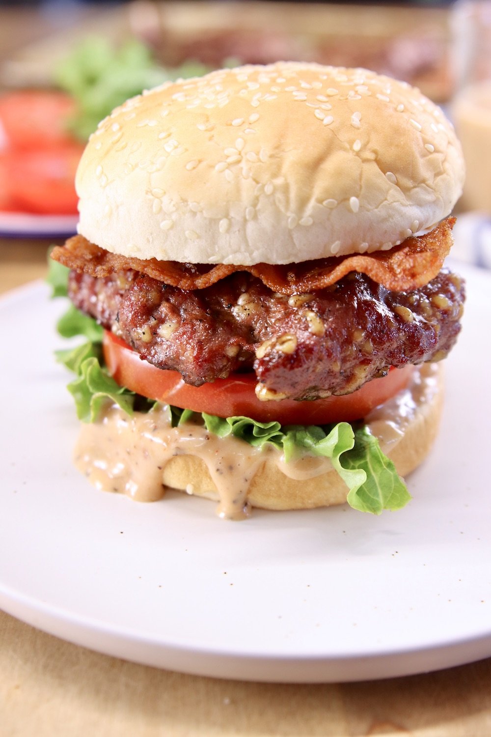 Burger with bacon, lettuce, tomato on a sesame seed bun