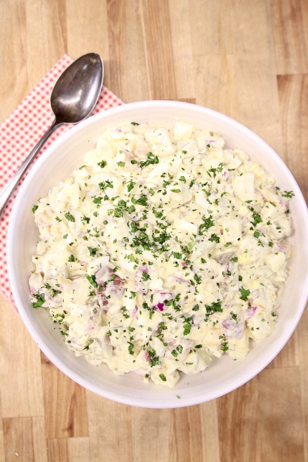 bowl of potato salad with a spoon