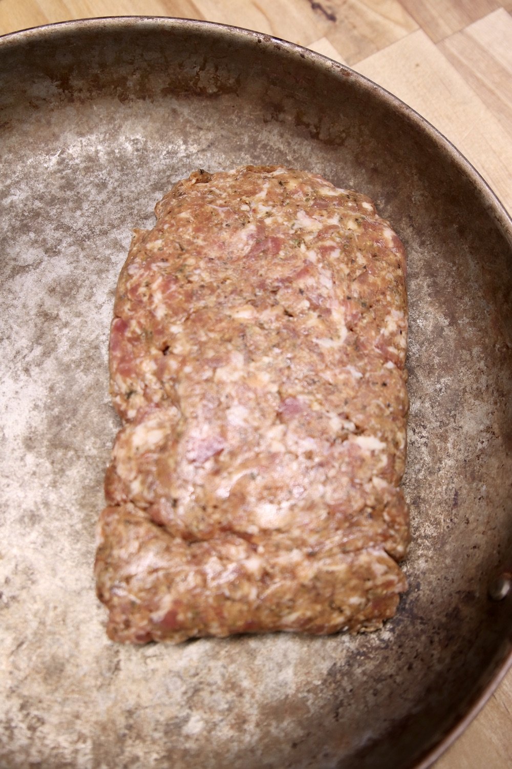 raw Italian sausage in a skillet