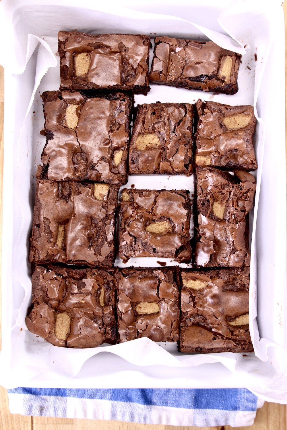 sliced brownies in a parchment lined dish