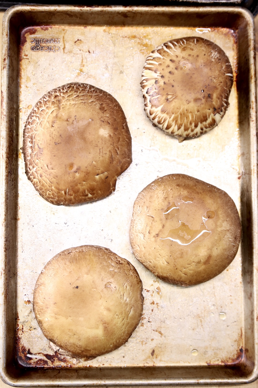 portobello mushrooms caps on a baking sheet