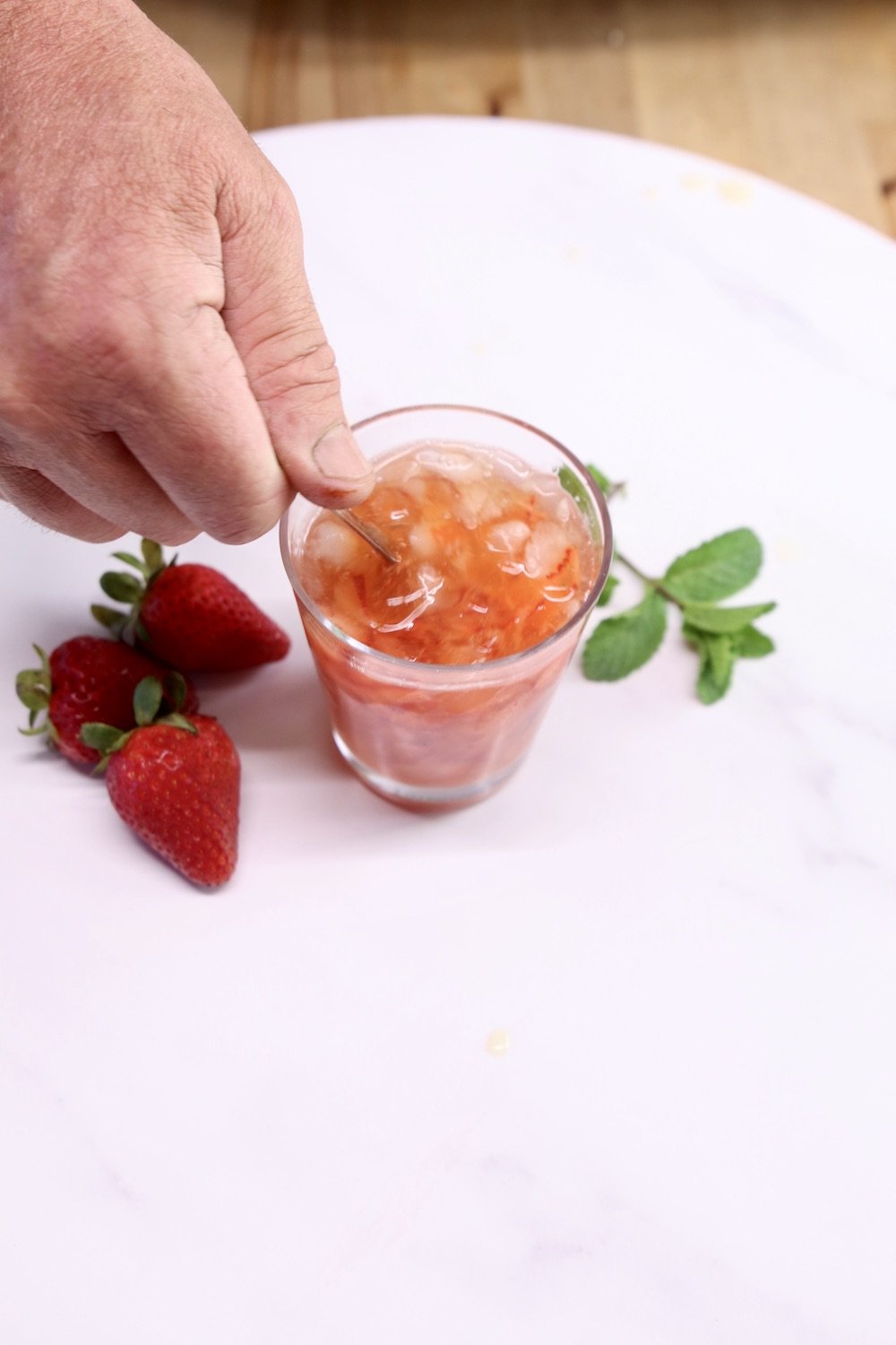Stirring a strawberry cocktail