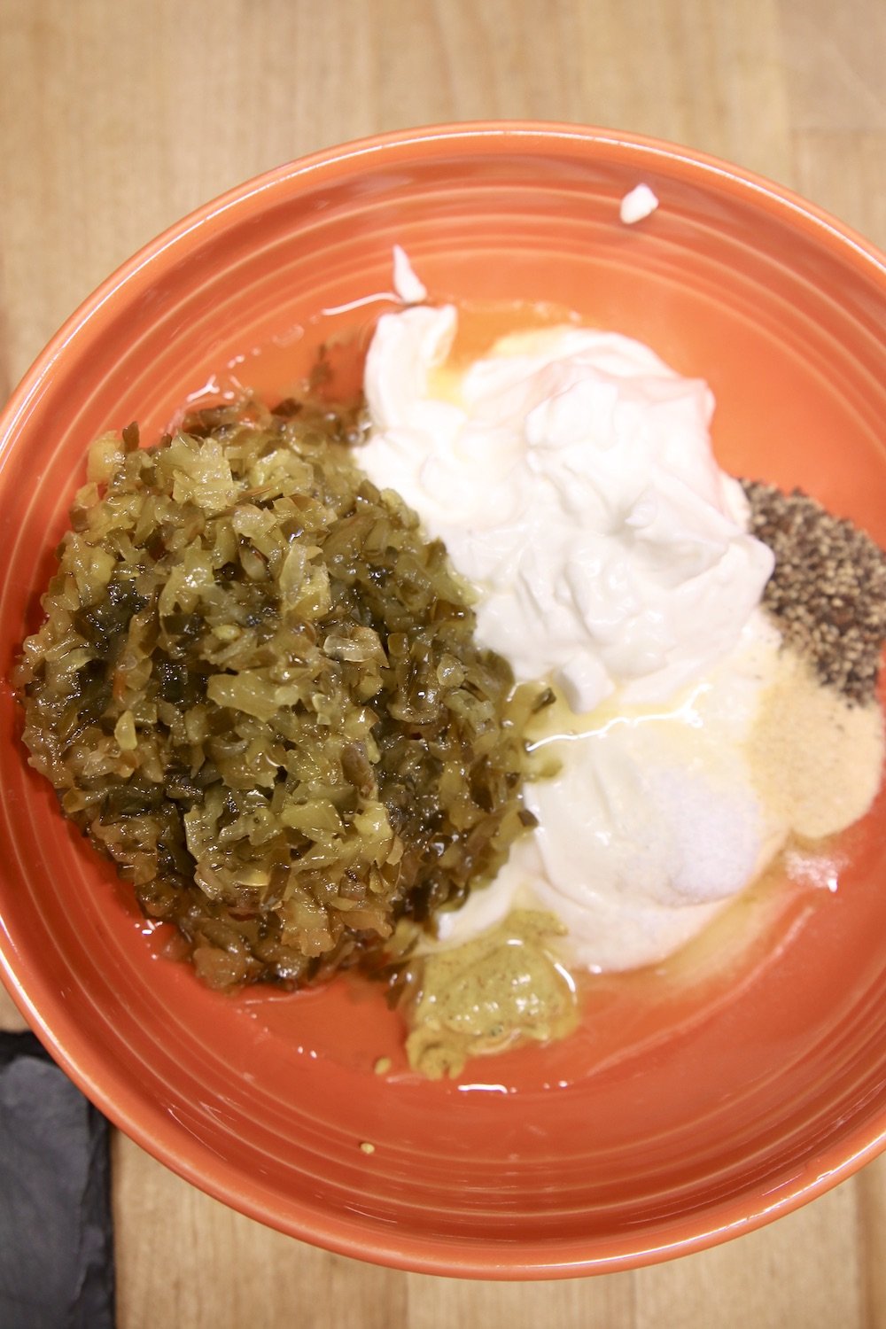 orange bowl with pickle relish, mayo, spices for dressing