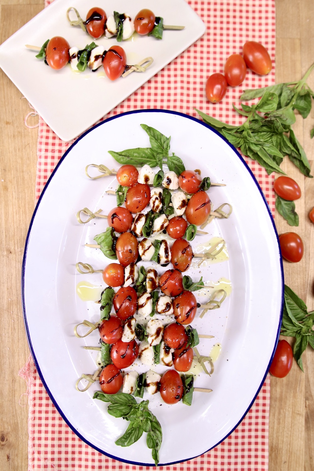 Caprese Salad Skewers appetizers on a platter & serving plate