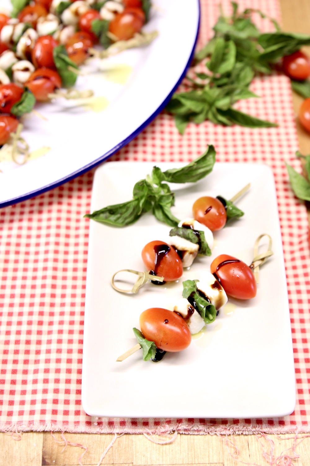 appetizer plate with 2 caprese salad skewers 