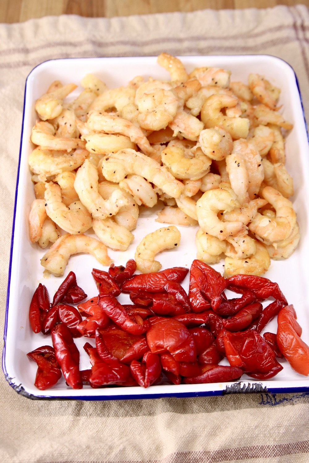 tray of grilled shrimp and red bell peppers
