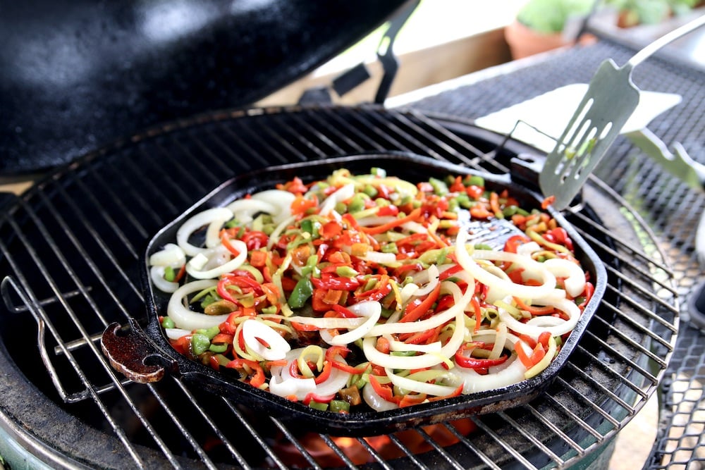 steak fajitas on a grill - peppers and onions