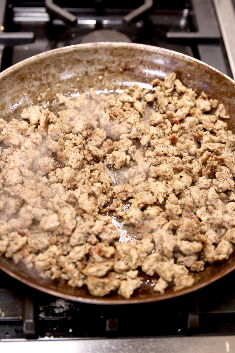 frying sausage in a skillet