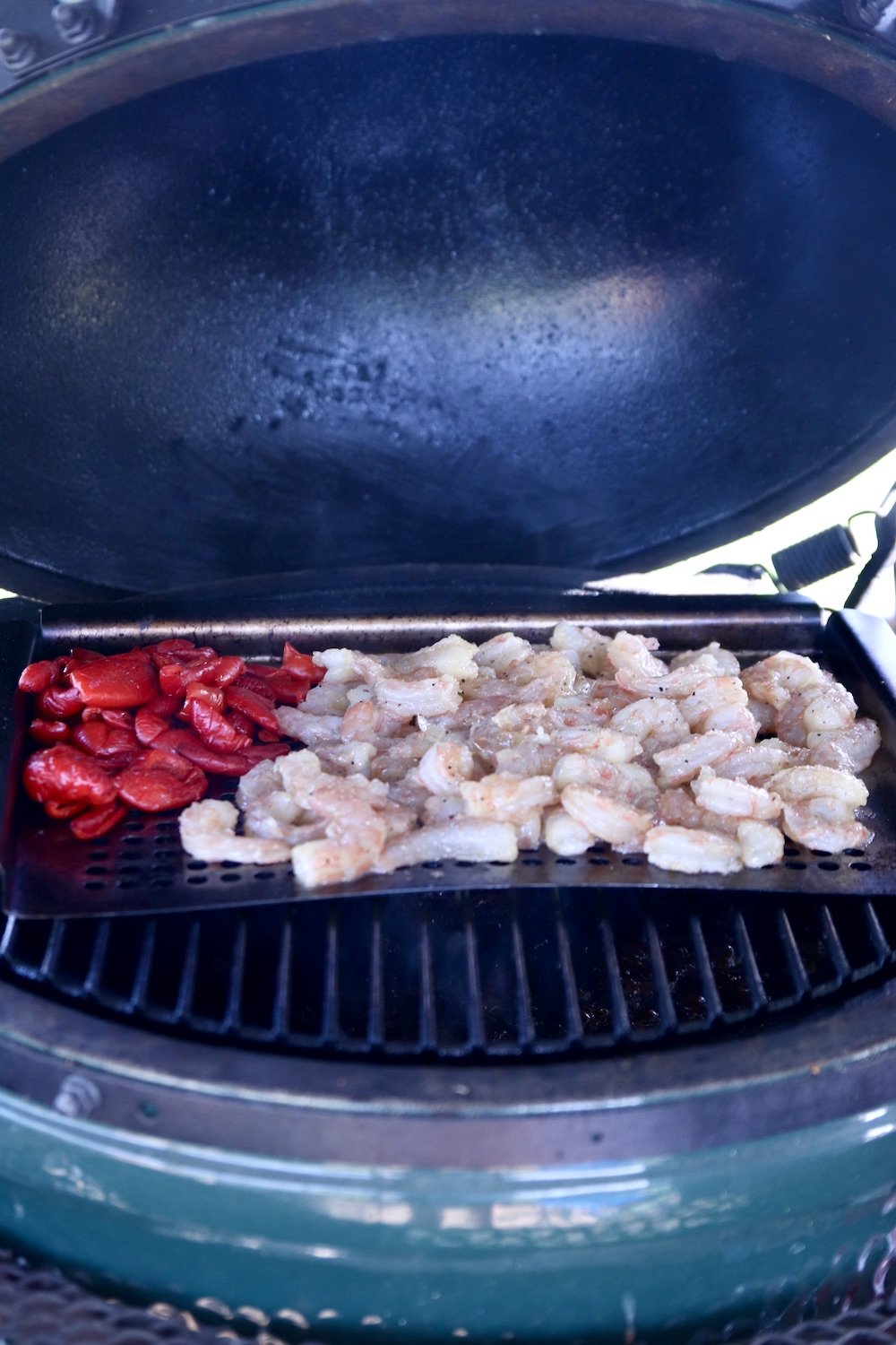 big green egg grill with a grill pan: red peppers and shrimp