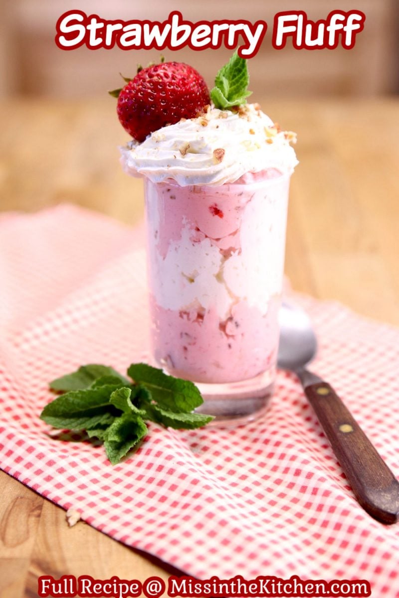 Strawberry Fluff in a serving glass topped with strawberry - text overlay