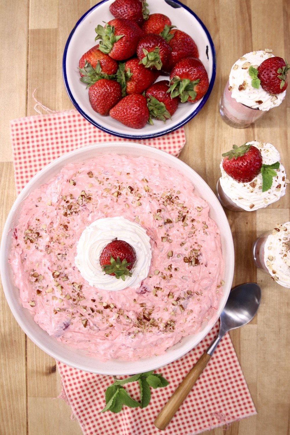 Strawberry Fluff Salad in a large bowl with a bowl of strawberries