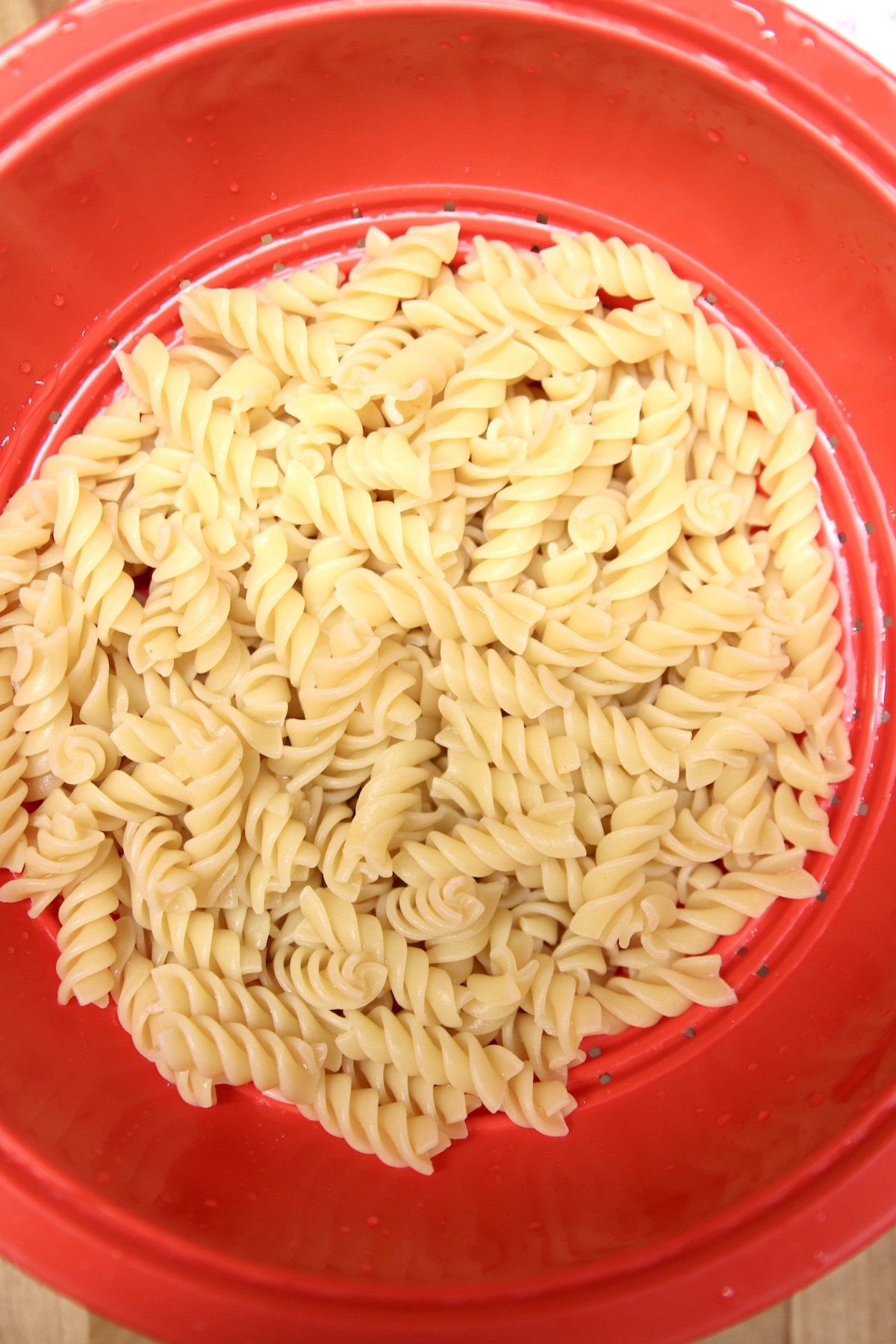 rotini pasta in a red colander