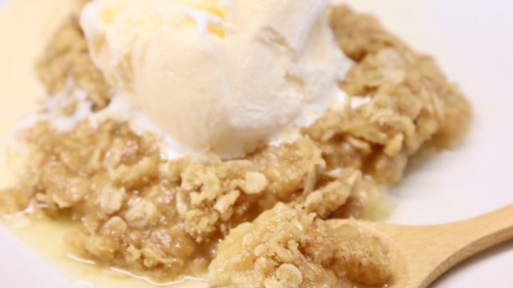 Pineapple Crisp on a plate topped with vanilla ice cream