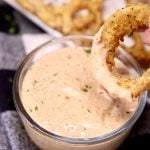 blooming onion sauce with an onion ring dipping Blooming Onion Sauce is a copycat version of the Outback Steakhouse dipping sauce perfect for their famous bloomin onion. A flavorful sauce that is simple to make with pantry ingredients.