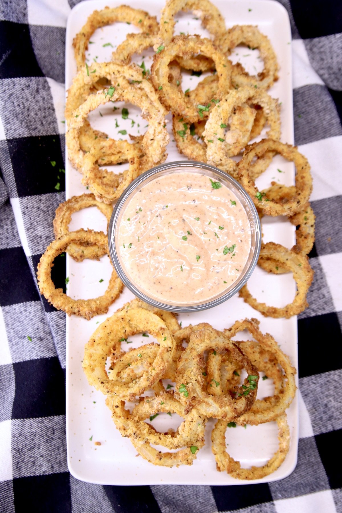 platter of sauce with onion rings
