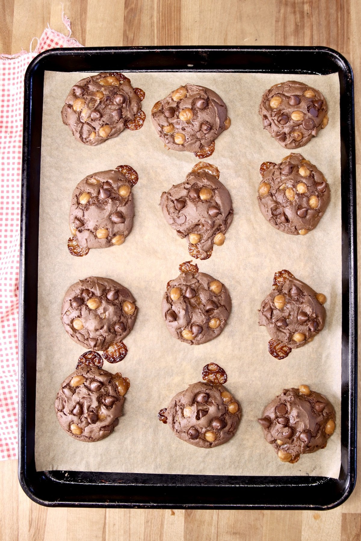 baked chocolate cookies on a baking sheet lined with parchment