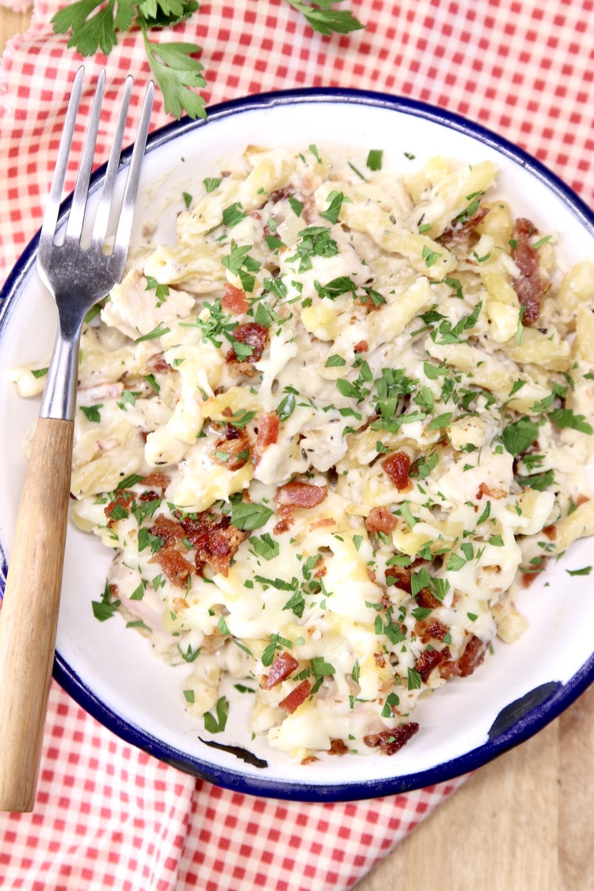 chicken and bacon pasta casserole on a plate with fork