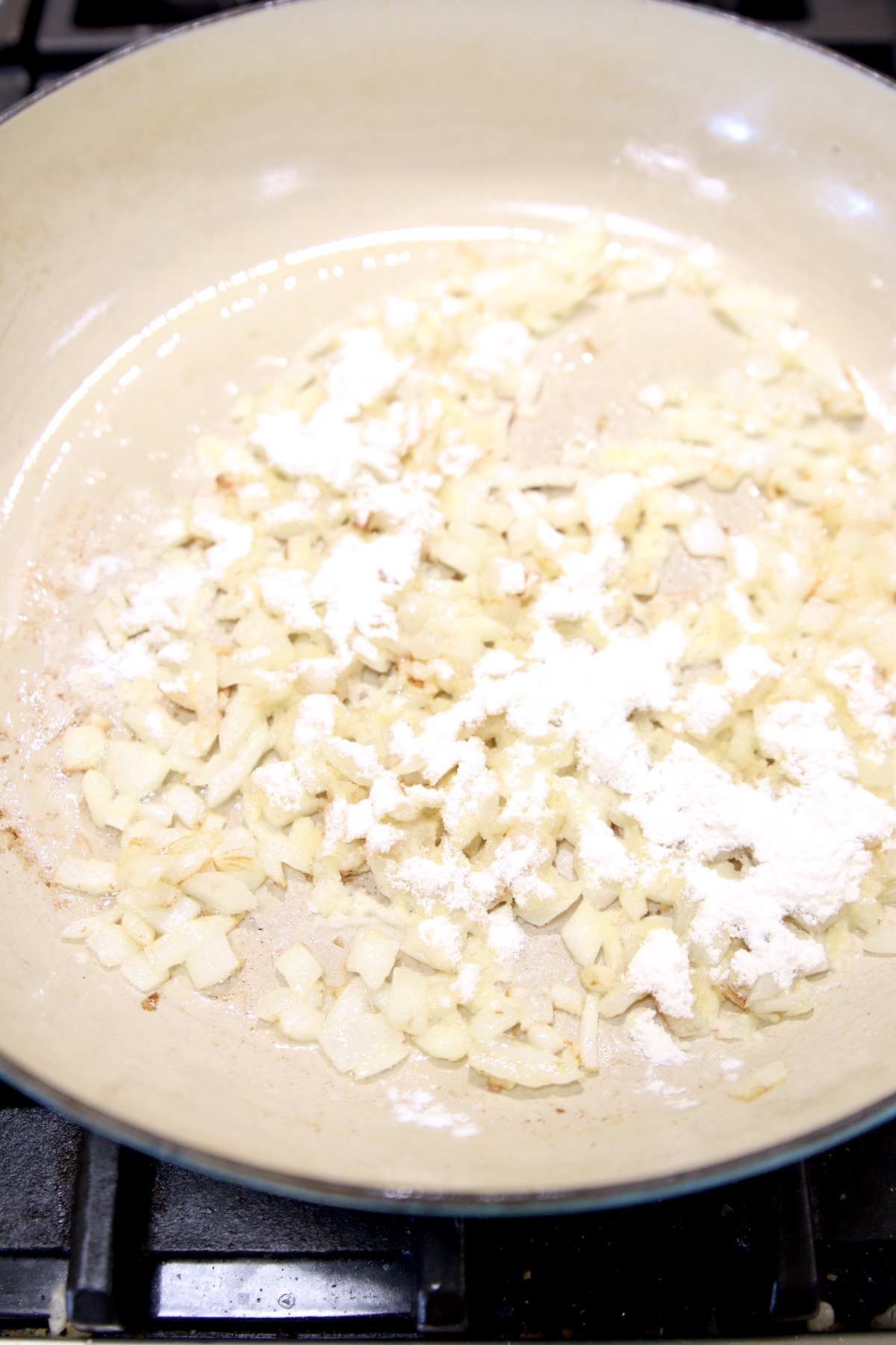 flour with onions and butter in a pan to make cheese sauce