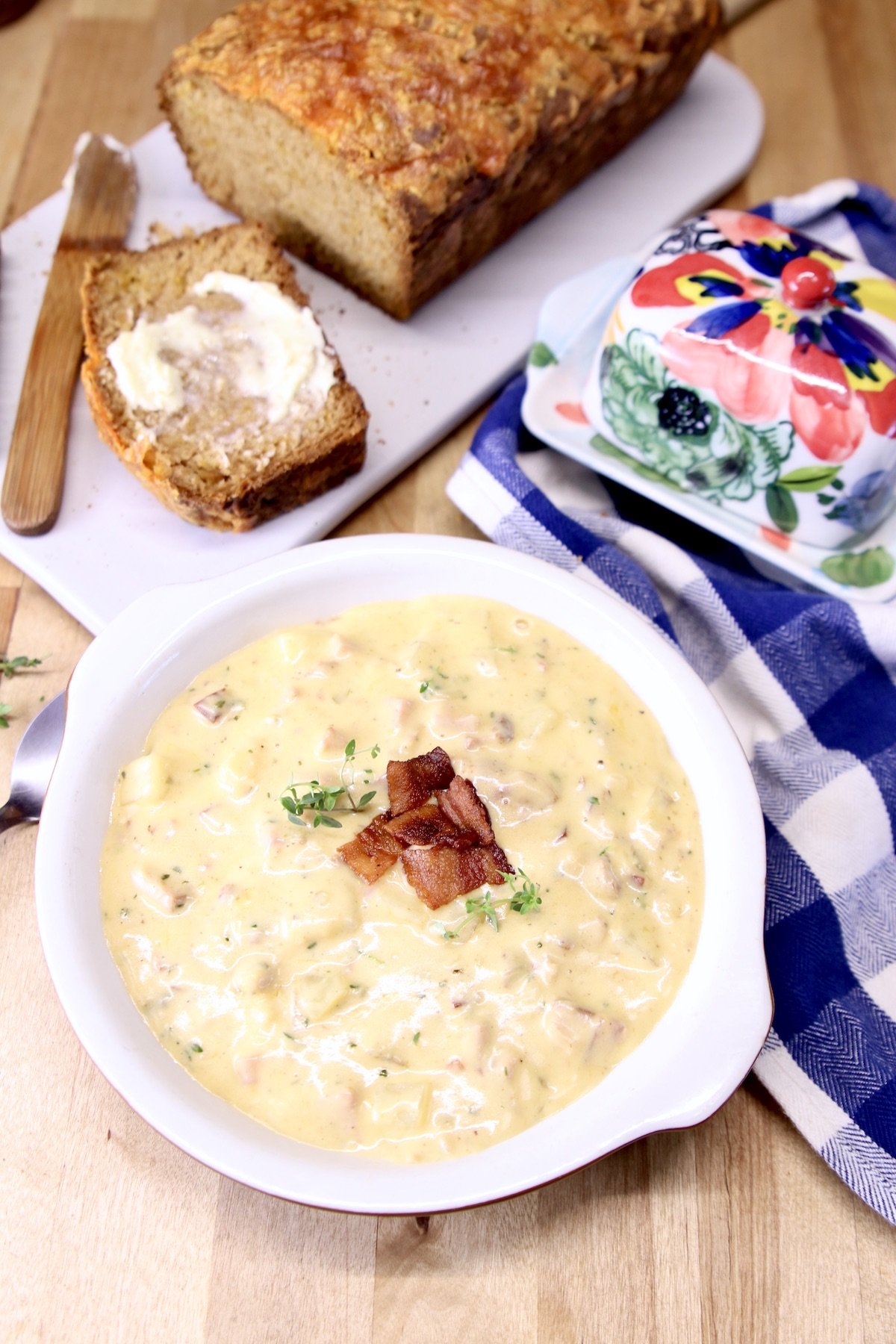 bowl of creamy soup with loaf of beer bread