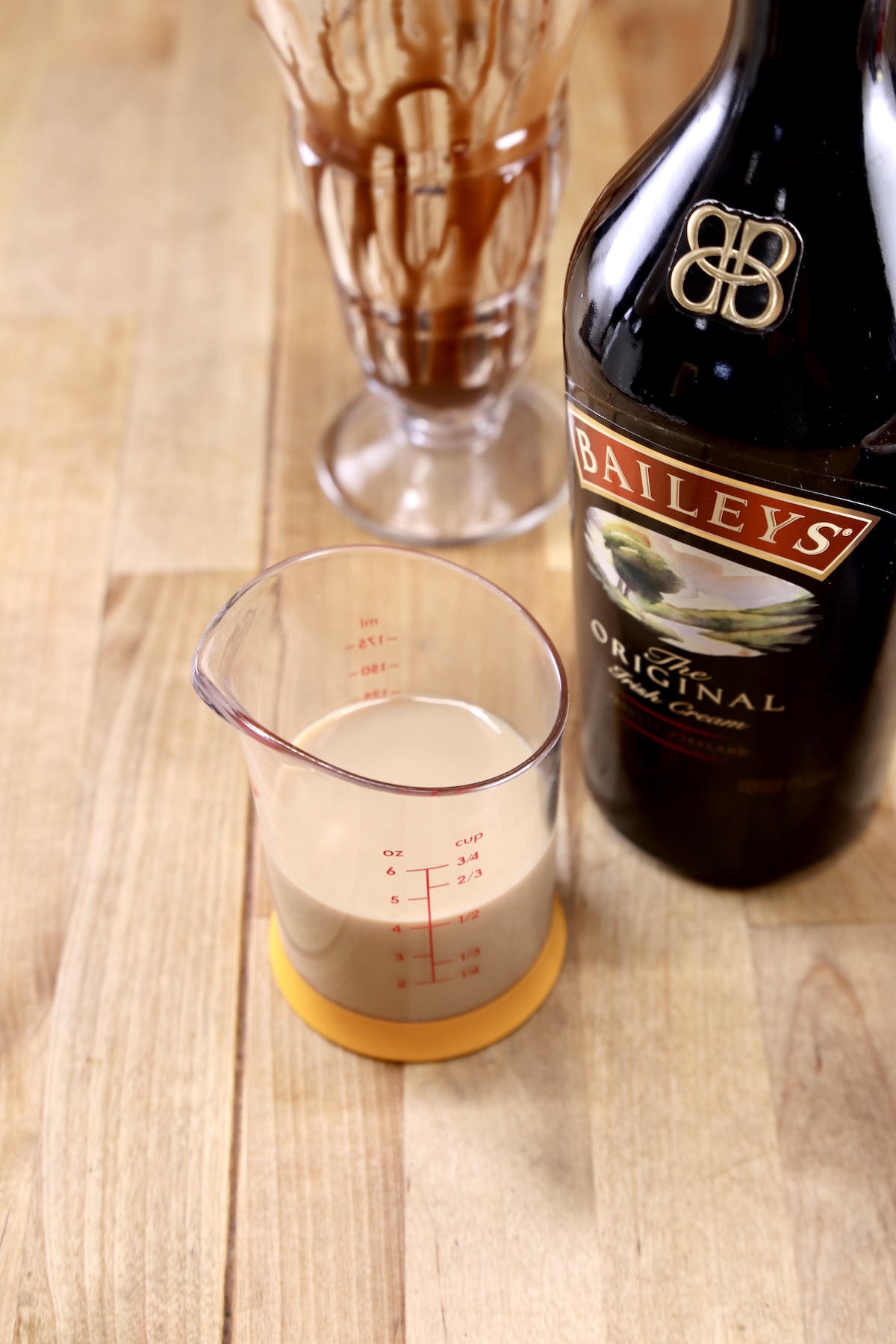 Baileys Irish Cream in a measure with bottle 