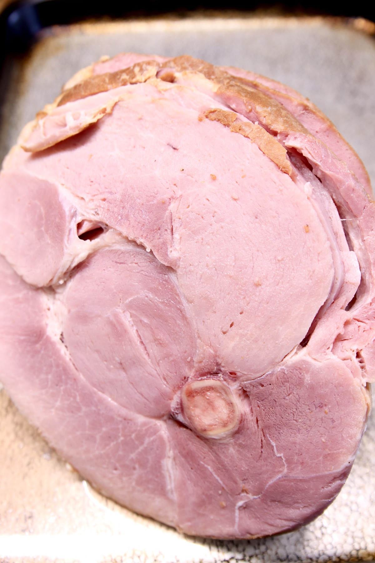 spiral sliced ham on a baking sheet