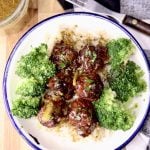 Meatballs with broccoli over rice in a shallow bowl