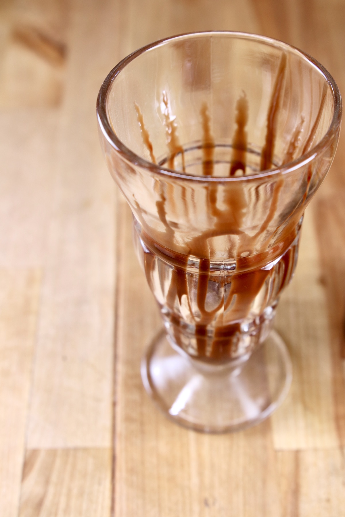 milkshake glass drizzled with chocolate syrup