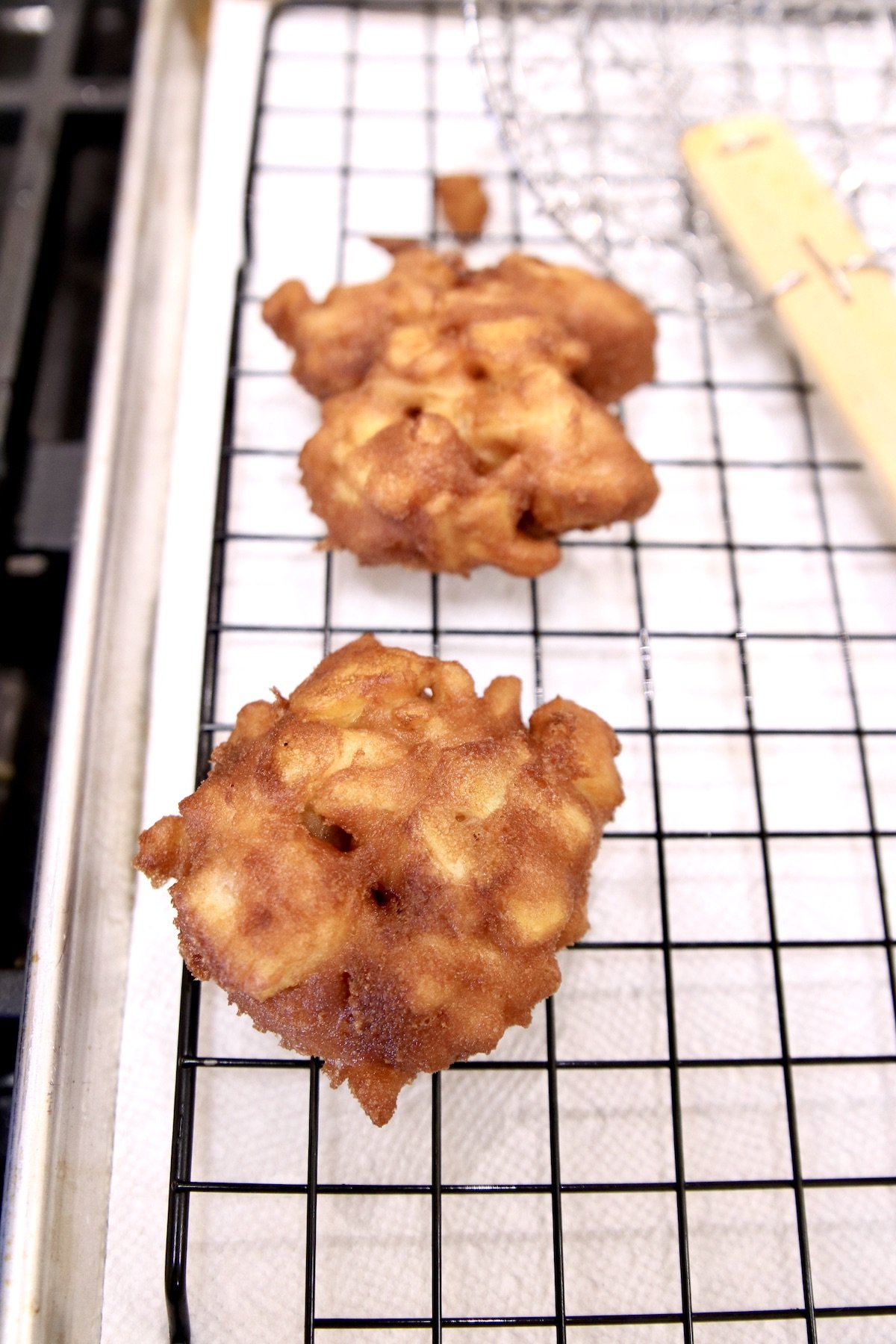 apple fritters on a wire rack