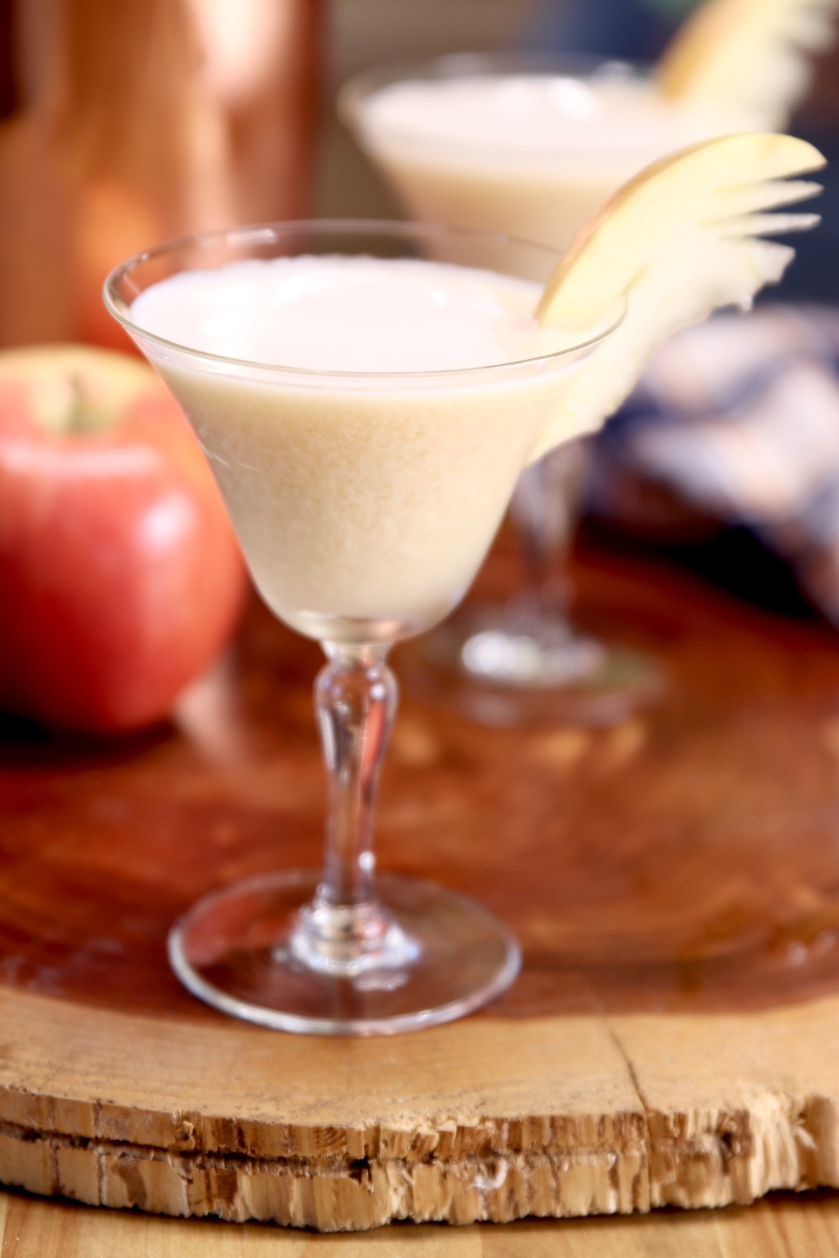 coupe glass with vodka martini - apple garnish