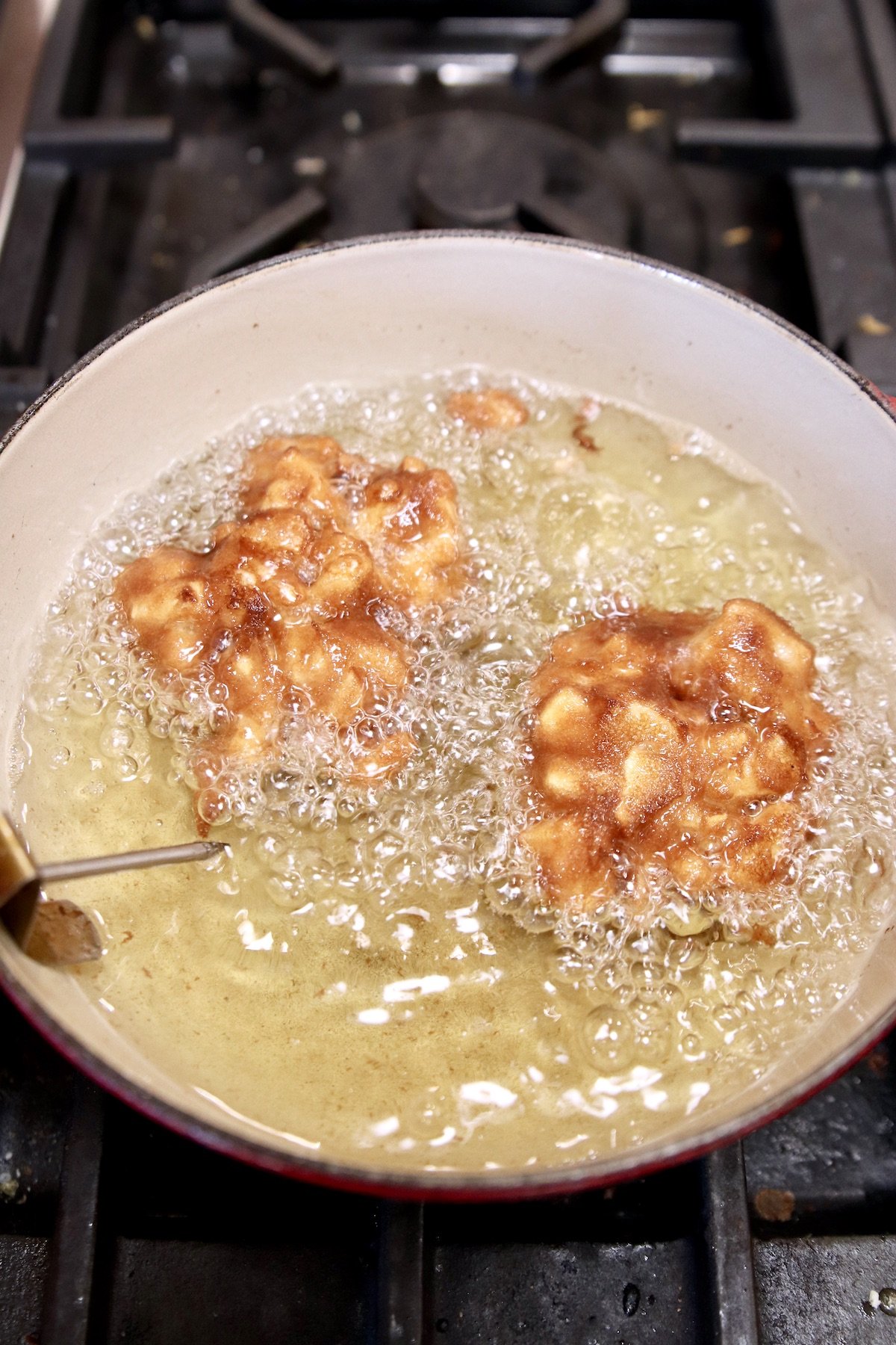 frying apple fritters in a pan