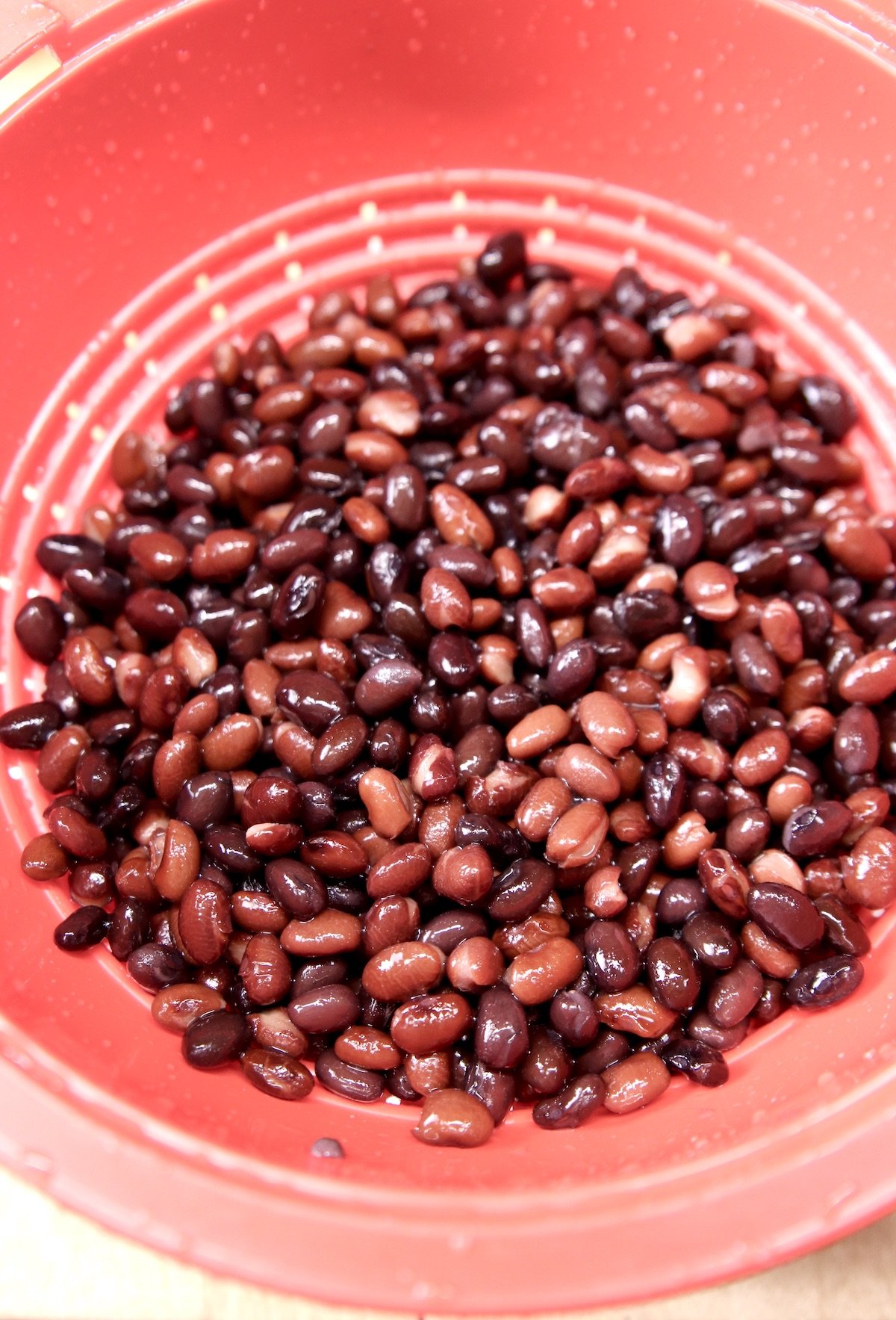 black beans in a red colander